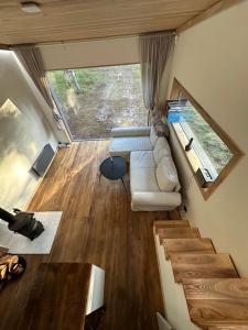 a living room with a couch and a table at The Lighthouse in Pāvilosta
