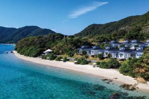 an aerial view of a beach with houses at Miru Amami in Tatsugo