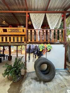 a porch with a tire on the side of a house at พาราไดซ์รีสอร์ต สังขละบุรี Paradise Resort at Sangkhlaburi in Sangkhla Buri