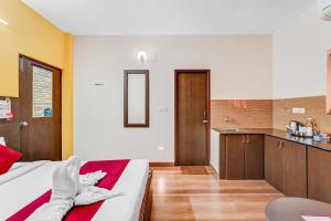 a hotel room with a bed and a kitchen at Season 4 Residences -Thiruvanmiyur Near Tidel park Apollo Proton cancer center and IIT Madras Research Park in Chennai