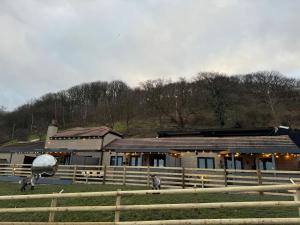 a building with sheep standing in front of it at Terfyn Hall holiday Apartment 2 in Prestatyn