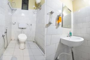 La salle de bains blanche est pourvue de toilettes et d'un lavabo. dans l'établissement FabExpress Sunrise By Vihasta, à Madgaon