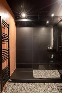 a bathroom with a shower with a glass door at Heritage & Tales: Belitiko in Litochoro