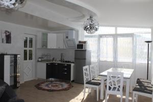a kitchen and dining room with a table and chairs at Lilac Apartments in Trogir