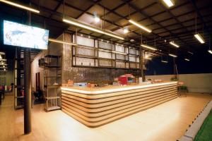 a restaurant with a long counter in a room at Portola Grand Arabia Hotel in Banda Aceh