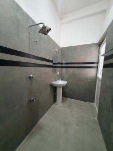 a bathroom with a sink and a shower at GypSea Madiha in Madihe East