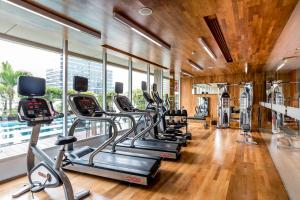 a gym with treadmills and elliptical machines at Hilton Garden Inn Bangkok Silom in Bangkok