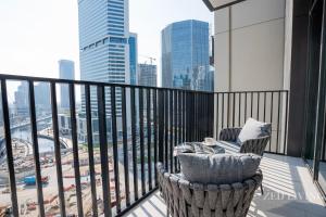 a balcony with a chair and a view of a city at Zed Living - Ahad Residences - 1BR High Rise Comforrt in Business Bay in Dubai