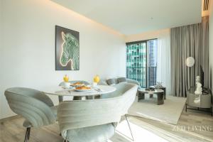 a living room with a table and chairs at Zed Living - Ahad Residences - 1BR High Rise Comforrt in Business Bay in Dubai