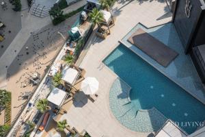 an overhead view of a swimming pool with tables and chairs at Zed Living - Ahad Residences - 1BR High Rise Comforrt in Business Bay in Dubai