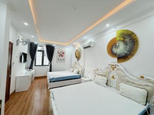 a bedroom with two beds in a room with wooden floors at Sky Star 2 Hotel in Can Tho