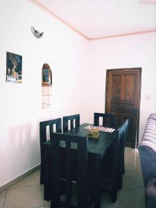 a dining room with a black table and chairs at Bree Airbnb in Malindi