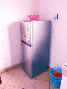 a stainless steel refrigerator in a corner of a room at Bree Airbnb in Malindi