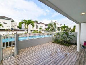 a porch with a fence and a swimming pool at Lovina B/22 at The Home Southlink in Nagoya