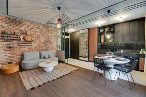 a living room with a couch and a table at Downtown Apartments DOKI Living - Foodhall & Parking in Gdańsk