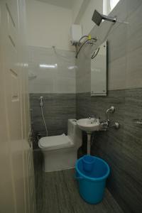 a bathroom with a toilet and a sink at N Cube Serviced Apartments in Hyderabad