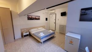 a bedroom with a bed and a flat screen tv at HB Appartamenti in centro Bergamo in Bergamo
