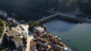 an aerial view of a river with buildings and a dock at Hotel Višegrad in Višegrad