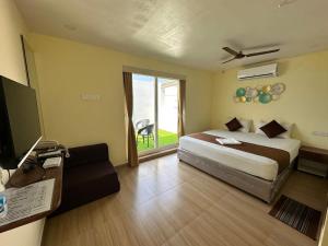 Letto o letti in una camera di Hotel Ramakrishna