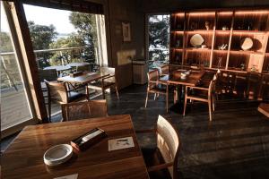 a restaurant with tables and chairs and a balcony at Miru Amami in Tatsugo