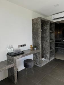 a kitchen with a stone counter and a stool at Villa Valeria in Ungasan