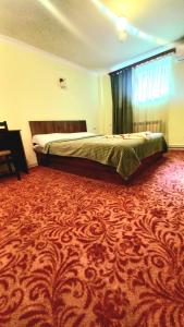 a bedroom with a bed and a red carpet at Hotel international in Yerevan