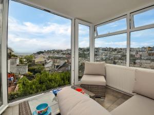 a living room with large windows and a couch at 3 Bed in Brixham 75230 in Brixham