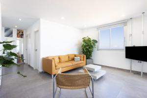 a living room with a couch and a tv at Home Of Tulio in Adeje