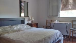 sypialnia z łóżkiem, stołem i 2 krzesłami w obiekcie Accogliente e ospitale B&B w mieście Perugia