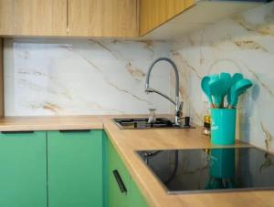 a kitchen with a sink and a counter top at apartment Tandau Astana in Taldykolʼ