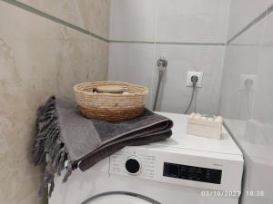 a basket sitting on top of a washing machine at Budget Studio by the Sea in Perea