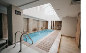 a pool in a building with a skylight at Baron Hotel Cairo in Cairo