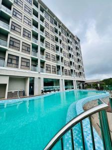 a large swimming pool in front of a building at Livingston Hotel in Sandakan