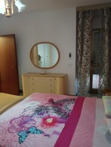 1 dormitorio con 1 cama con tocador y espejo en bandiera blu, en Marina di Gioiosa Ionica