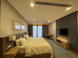 a hotel room with a bed and a television at 188 suites By Seng Home in Kuala Lumpur