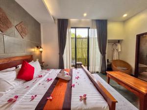 a bedroom with a bed with pink flowers on it at The Palmery in Siem Reap