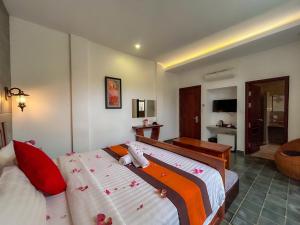 a hotel room with two beds and a bathroom at The Palmery in Siem Reap