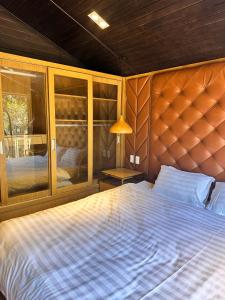 a bedroom with a large bed and a window at Mongo Garden in Da Lat