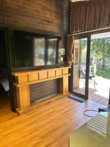 a living room with a large flat screen tv at Mongo Garden in Da Lat