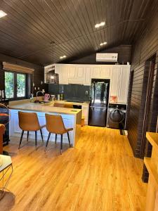 a kitchen with white cabinets and a wooden floor at Mongo Garden in Da Lat