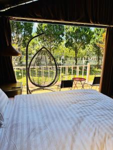 a bedroom with a bed and a swing at Mongo Garden in Da Lat