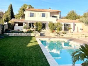 莫桑萊阿爾皮萊的住宿－Bastide La Mérigot - Maussane-les-Alpilles，庭院前带游泳池的房子