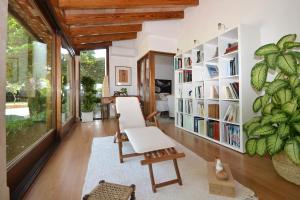 a living room with a book shelf and a chair at Villa Bennassar in Inca