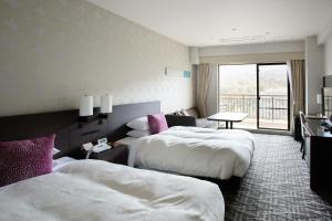 Postel nebo postele na pokoji v ubytování Hotel Harvest Kinugawa