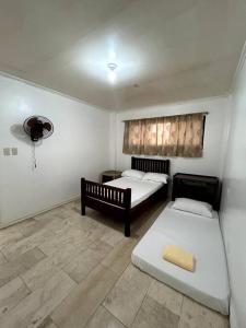 a room with two beds in a room at Bobby's Villa Beachfront, Bauang in Bauang