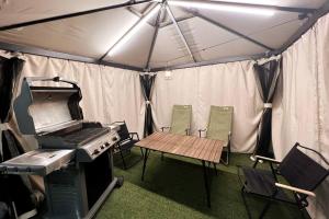 a tent with a picnic table and a grill at Pet Friendly 301 in Suncheon