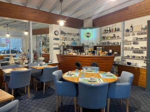 a restaurant with tables and chairs and a counter at Hôtel de la Plage in Fécamp