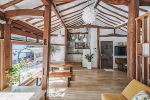 a living room with wooden ceilings and a wooden table at And spring in Jeonju