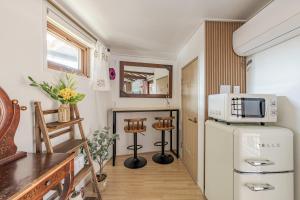 a small kitchen with a refrigerator and a microwave at And spring in Jeonju
