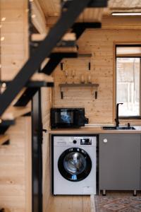 a washer and dryer in a tiny house at SMART Via Kazbegi in Stepantsminda